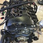 Car engine assembly on workshop floor