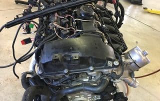 Car engine assembly on workshop floor