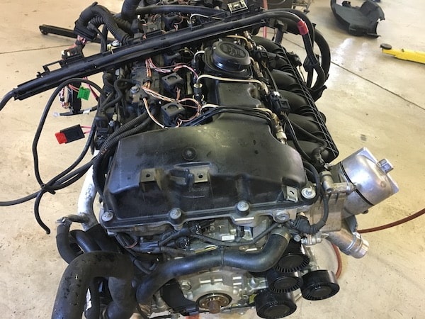 Car engine assembly on workshop floor
