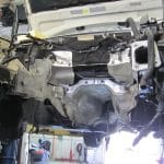 Car underside with engine removed in garage