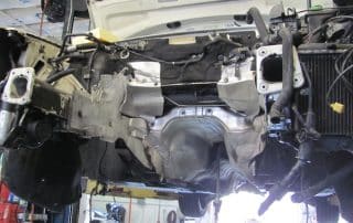 Car underside on lift with engine removed
