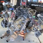 Car engine and suspension assembly in garage