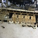 Car engine underside with oil pan removed