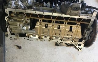 Car engine underside with oil pan removed