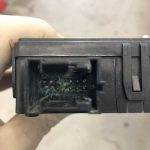 Corroded electronic connector inside black plastic housing
