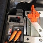 Electric vehicle battery compartment with orange high-voltage cables