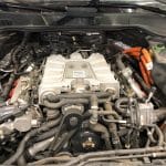 Car engine bay with hybrid components and wiring