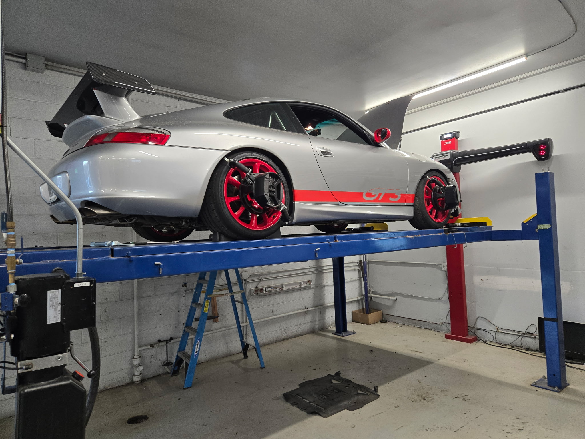 Silver Porsche 911 GT3 on alignment rack