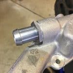 Close-up of metal automotive component with fitting