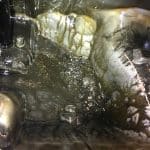 Dirty industrial sink with murky water buildup