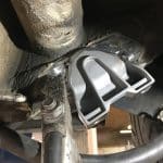 Welded metal bracket under vehicle chassis