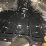 Oily automotive component under vehicle chassis