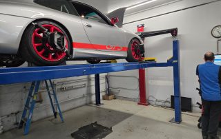 Porsche 911 GT3 on lift during wheel alignment