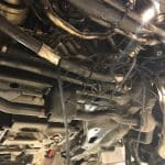 Underside of vehicle showing suspension and exhaust components