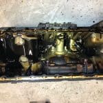 Removed engine oil pan with oil residue inside