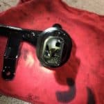 Black automotive oil pickup tube on red cloth