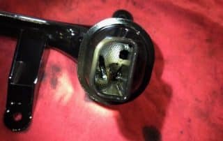 Black automotive oil pickup tube on red cloth
