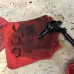 Greasy car part on red shop rag