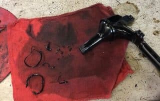 Greasy car part on red shop rag