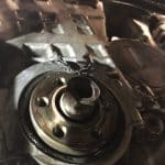Damaged engine component with metal shavings and oil residue