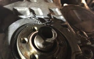 Damaged engine component with metal shavings and oil residue