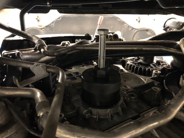 Automotive puller tool on engine component