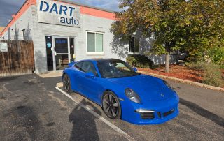 Blue Porsche parked outside DART Auto shop