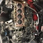 Car engine block with exposed cylinders in engine bay