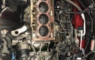 Car engine block with exposed cylinders in engine bay