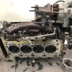 Disassembled car engine with turbocharger on workbench