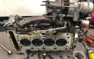 Disassembled car engine with turbocharger on workbench