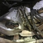 Car transmission housing with visible oil leak