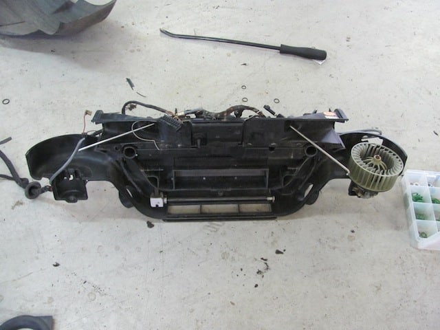 Disassembled car HVAC unit on workshop floor