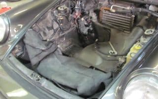 Empty front trunk of classic car under repair