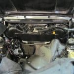 Empty car engine bay with hood open