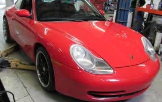 Red Porsche 911 in auto repair shop