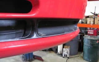 Close-up of red car front bumper