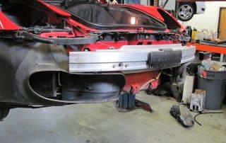 Red sports car with front bumper removed