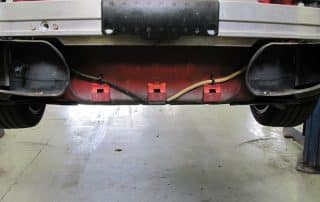 Underside of car rear bumper and exhaust system