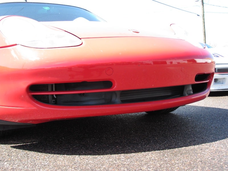 Close-up of red sports car front bumper