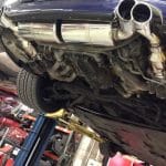 Car underside with dual exhaust on lift