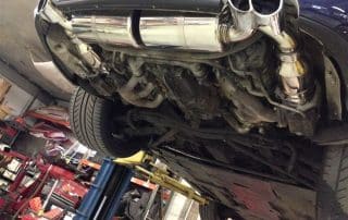 Car underside with dual exhaust on lift