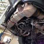 Car underside with exhaust system on lift