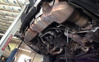 Car underside with exhaust system on lift