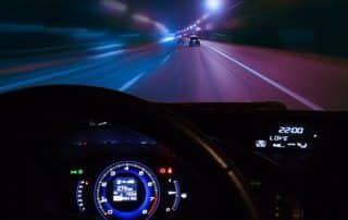 Nighttime highway view from car dashboard