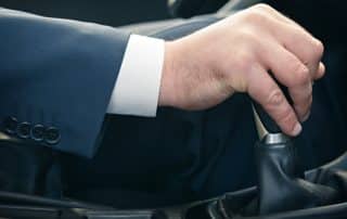 Man shifting manual car gear stick