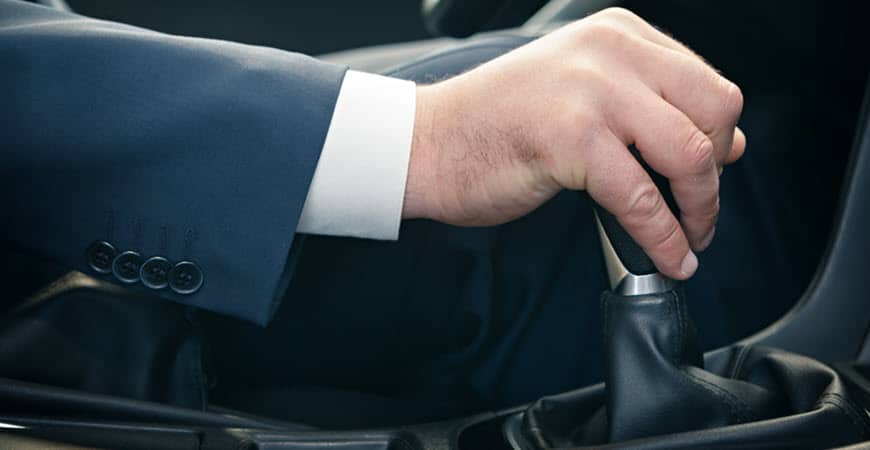 Man shifting manual car gear stick