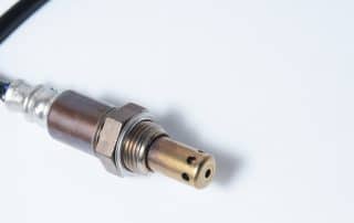 Close-up of automotive oxygen sensor with wire