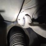 Close-up of car suspension control arm and bushing