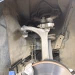 Car suspension and brake assembly inside wheel well